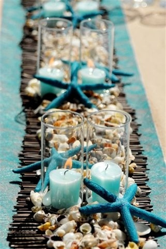 Beach Wedding Table Decorations
 Picture a bamboo runner seashells and pebbles