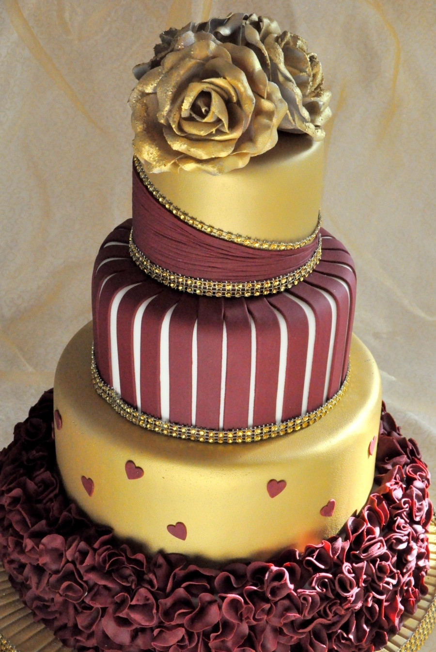 Burgundy Wedding Cakes
 Gold And Burgundy Wedding Cake With Ruffles And Roses