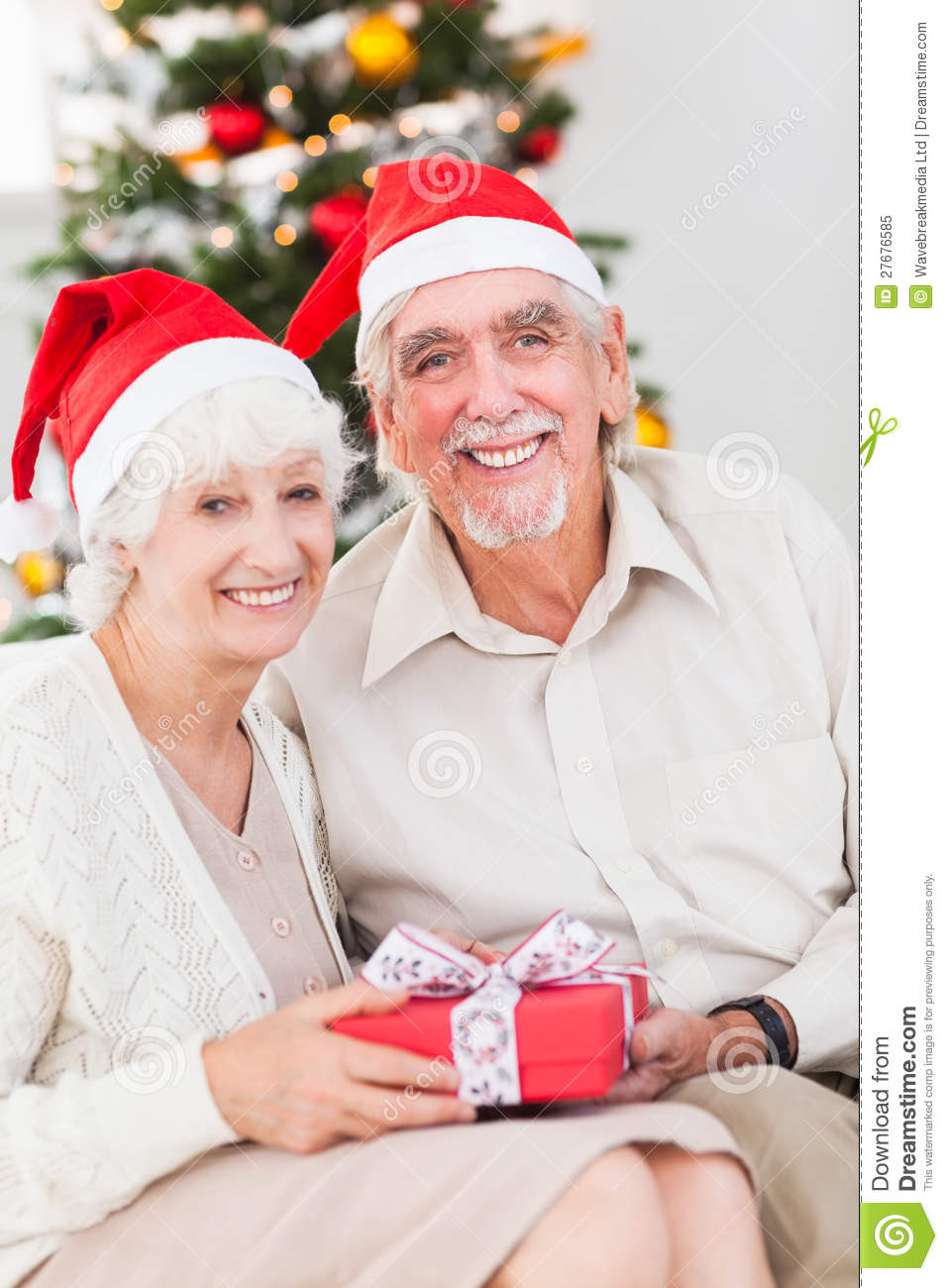 Christmas Gift Ideas For Older Couples
 Smiling Old Couple Swapping Christmas Gifts Stock Image
