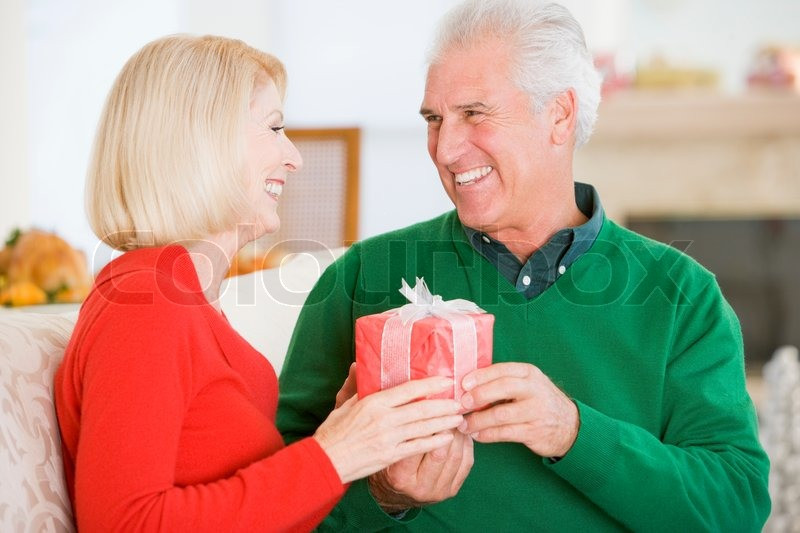 Christmas Gift Ideas For Older Couples
 An elderly couple in love exchanging ts on Christmas