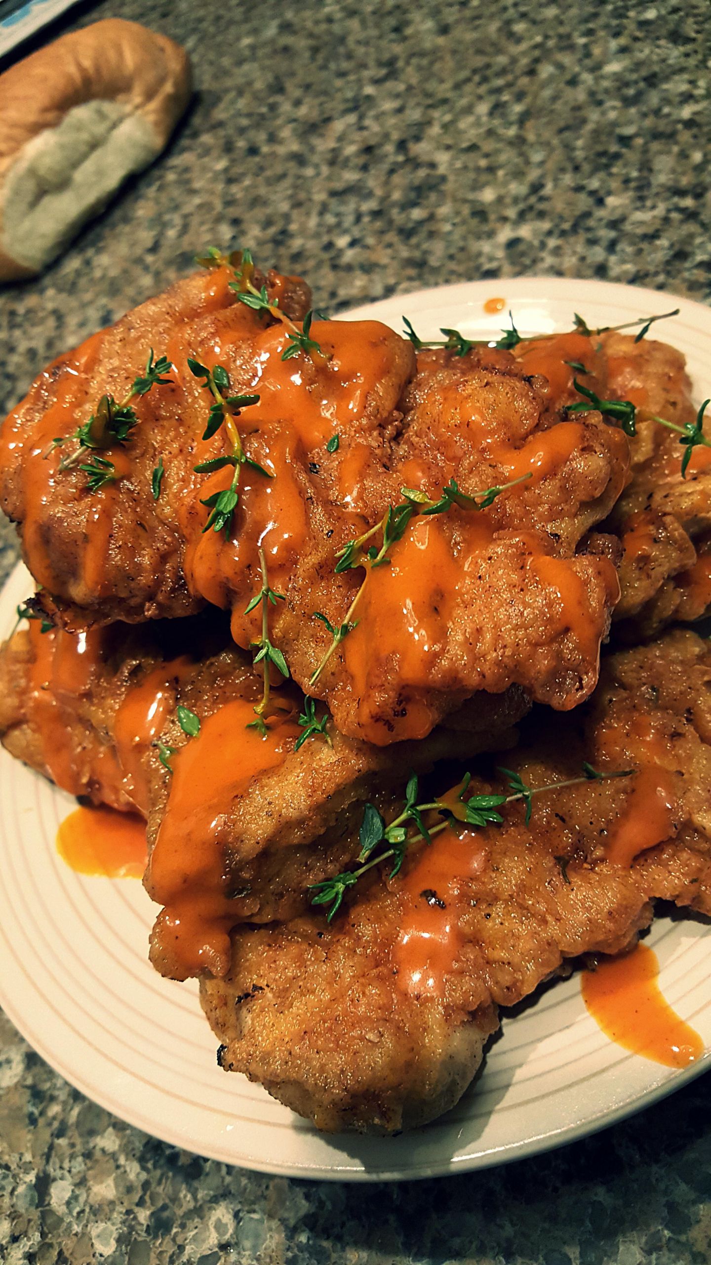 Deep Fried Boneless Chicken Thighs
 deep fried chicken thighs with hot sauce and thyme sprigs