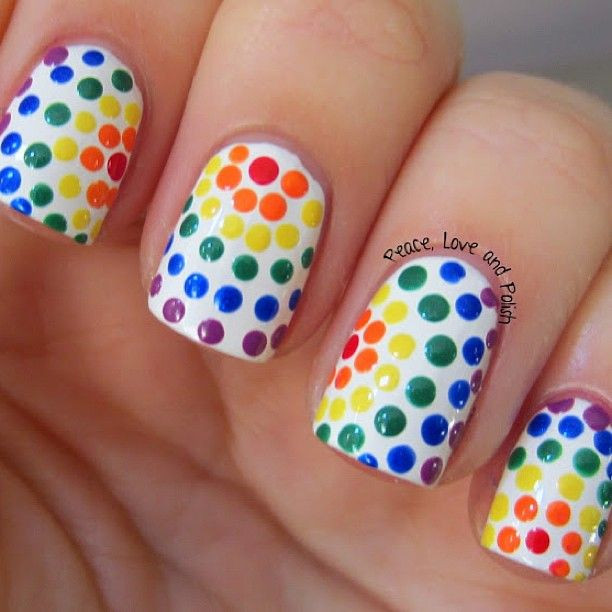 Dots Nail Art
 White nails with multi color Rainbow polka dots free hand