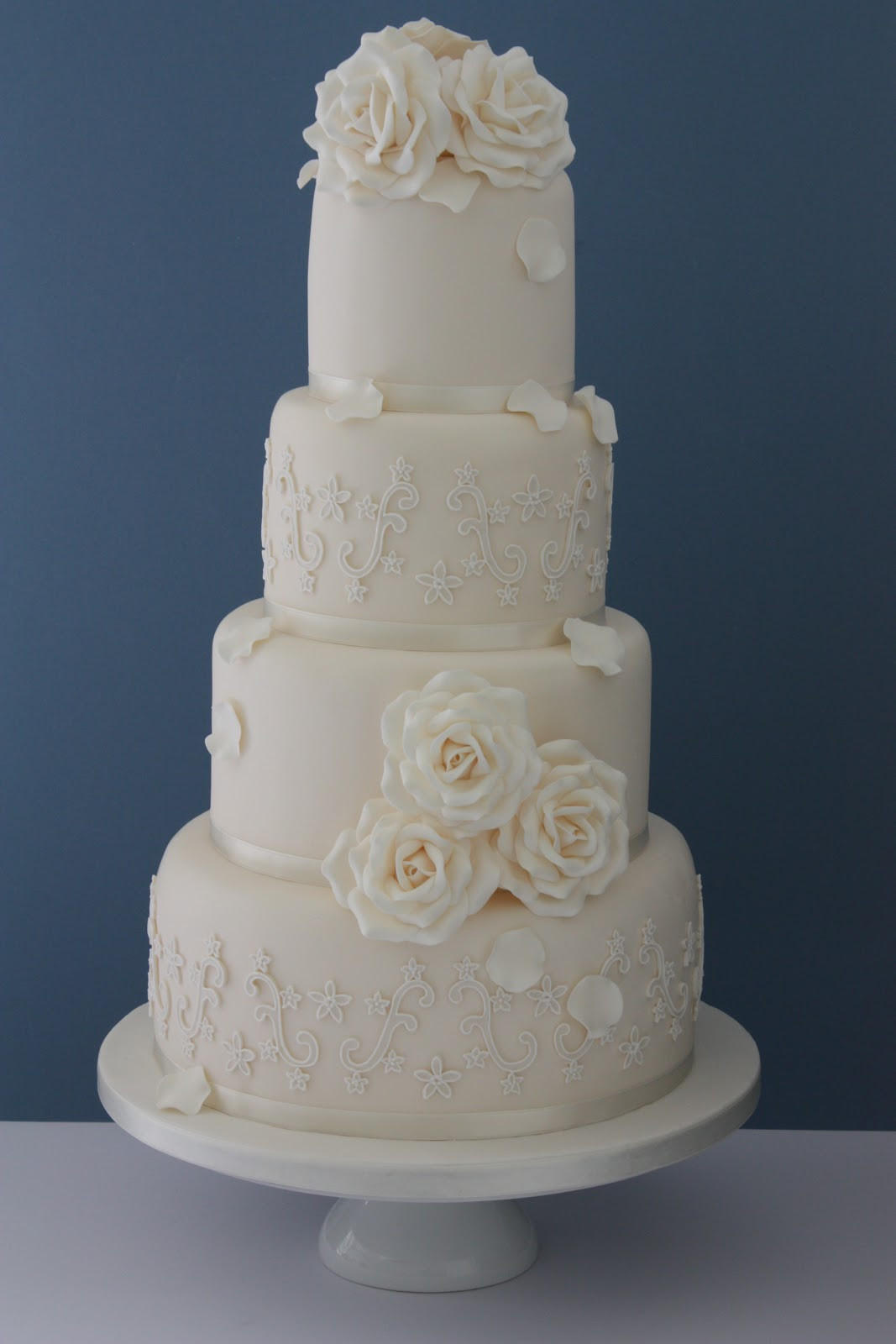 Lace Wedding Cake
 Tiers & Tiaras Ivory Roses & Piped Lace Wedding Cake