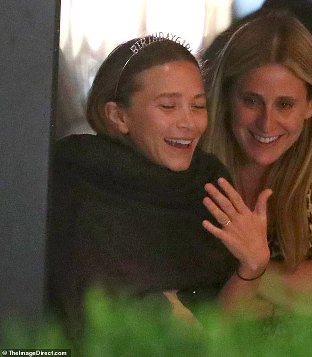 Mary Kate And Ashley Birthday Party
 Ashley Olsen wears a black dress as sister Mary Kate rocks