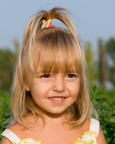 Medium Hairstyles For Little Girls
 Little girl with her hair styled into a fountain
