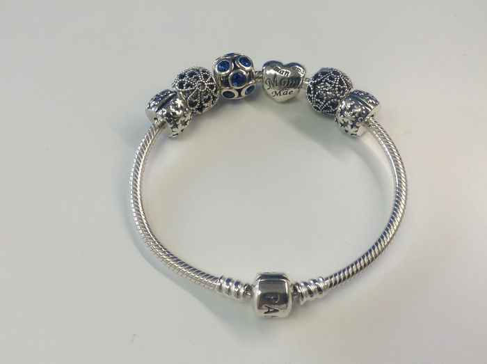 Pandora Silver Bracelet
 Silver Pandora bracelet with charms and stoppers Catawiki