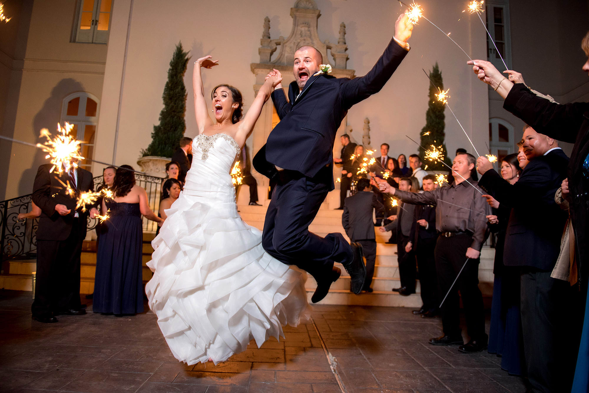 Wedding Sparklers Houston
 Sparkler exit at Chateau Co ar Bride and Groom jumping
