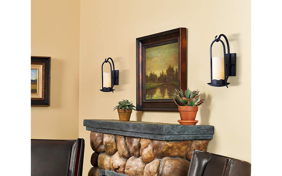 Living Room Wall Sconces
 Rustic wall sconces brighten a living room fireplace