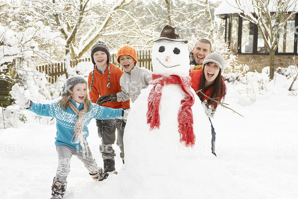 Winter Family Activities
 A Family With Two Children Building A Snowman Stock